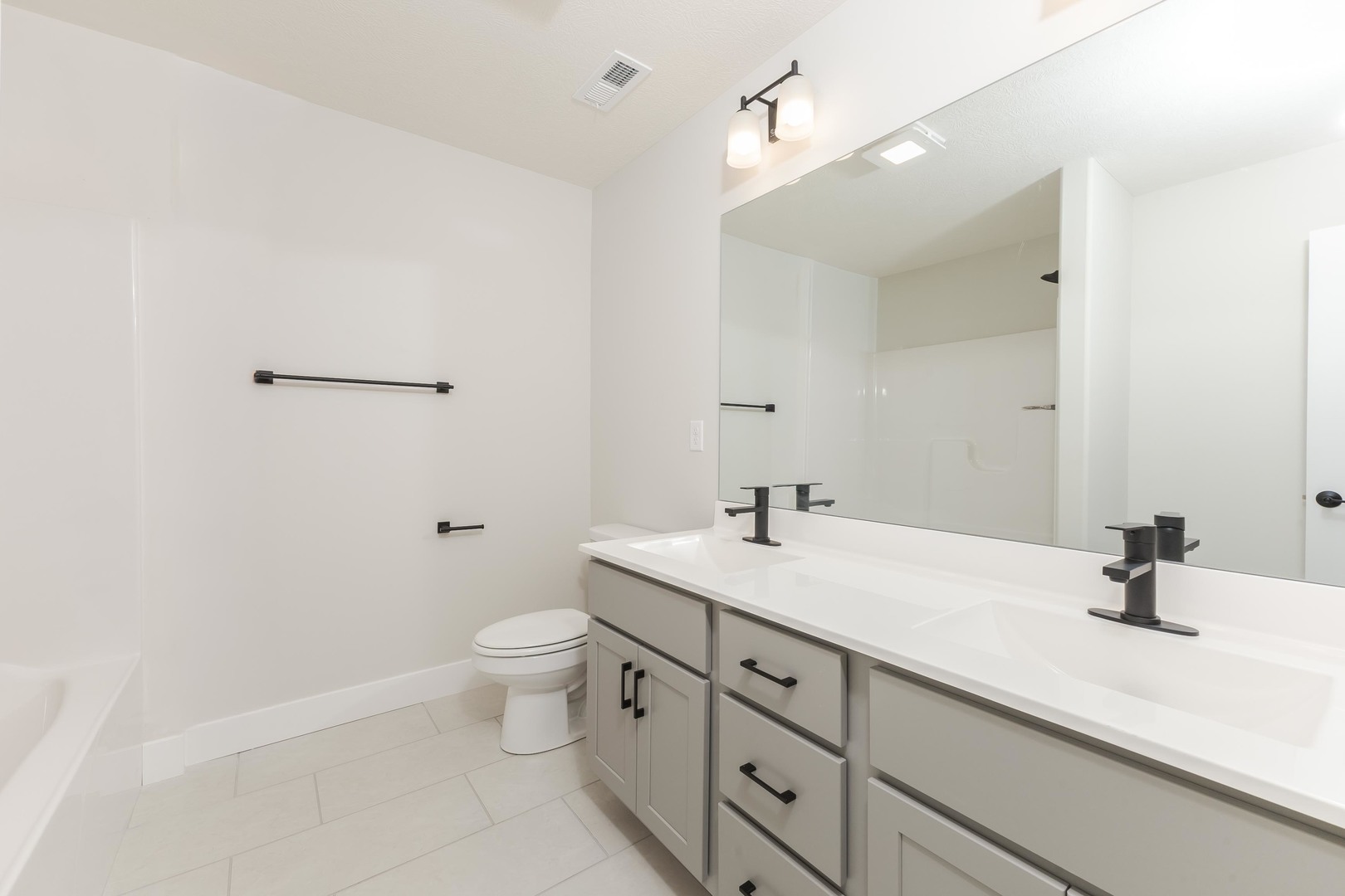 1004 Mount Carmel Road Bloomington, IL 61705 - Photo 31 of 44 a bathroom with a sink a toilet and a mirror