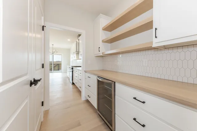 a view of a kitchen with white cabinets and a stove