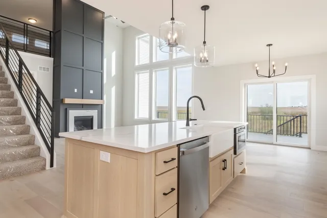a kitchen with a sink and a chandelier