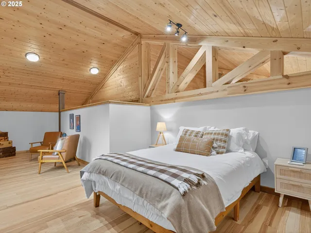 a bedroom with a bed a chair and the view