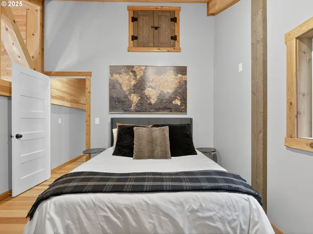 a bedroom with a bed and painting on the wall