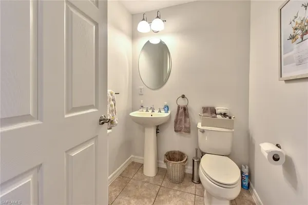 a bathroom with a toilet a sink and a mirror