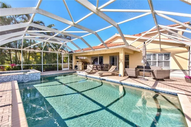 a view of a patio with table and chairs under an umbrella