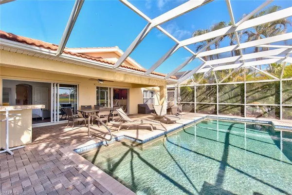 a view of a house with backyard and sitting area