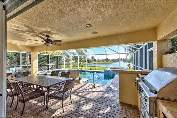 a view of a patio with a table chairs and a couple of flower plants