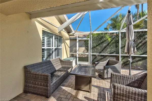 an outdoor sitting area with furniture and wooden deck