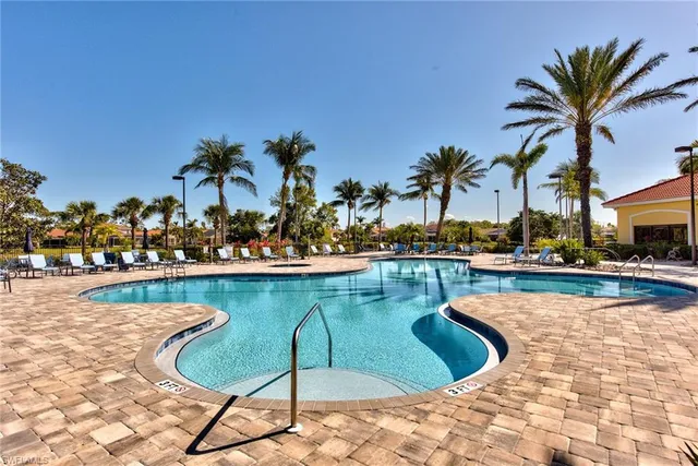 a view of a swimming pool with chair and table