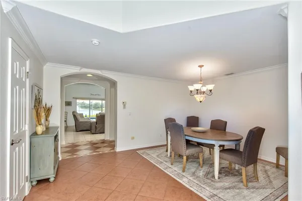 a view of a dining room with furniture and chandelier