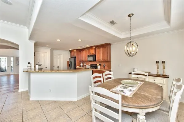 a large kitchen with a table and chairs