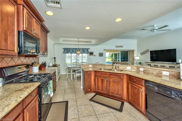a kitchen with lots of counter top space appliances and cabinets
