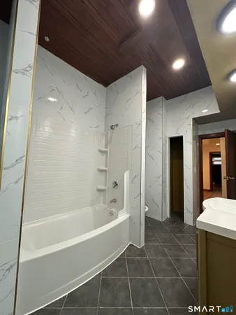 a bathroom with a bathtub and a shower