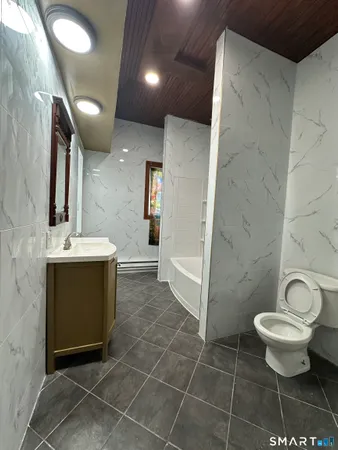 a bathroom with a sink toilet and shower
