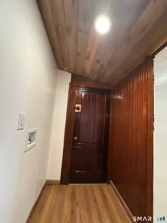a view of hallway with wooden floor