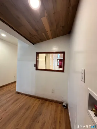 a view of a room with wooden floor and a fireplace