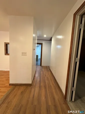 a view of hallway with wooden floor