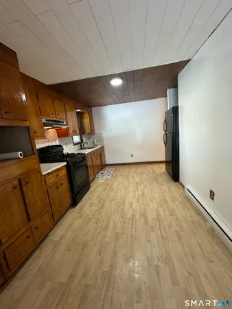 a view of a room with wooden floor