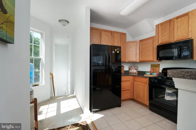 a kitchen with stainless steel appliances granite countertop a refrigerator stove and microwave