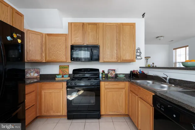 a kitchen with a sink stove and microwave