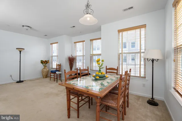a view of a dining room with furniture and window