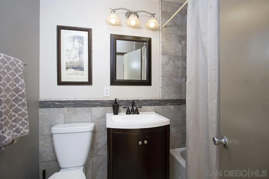 9228 Bellagio Road Santee, CA 92071 - Photo 11 of 25 a bathroom with a toilet sink and mirror
