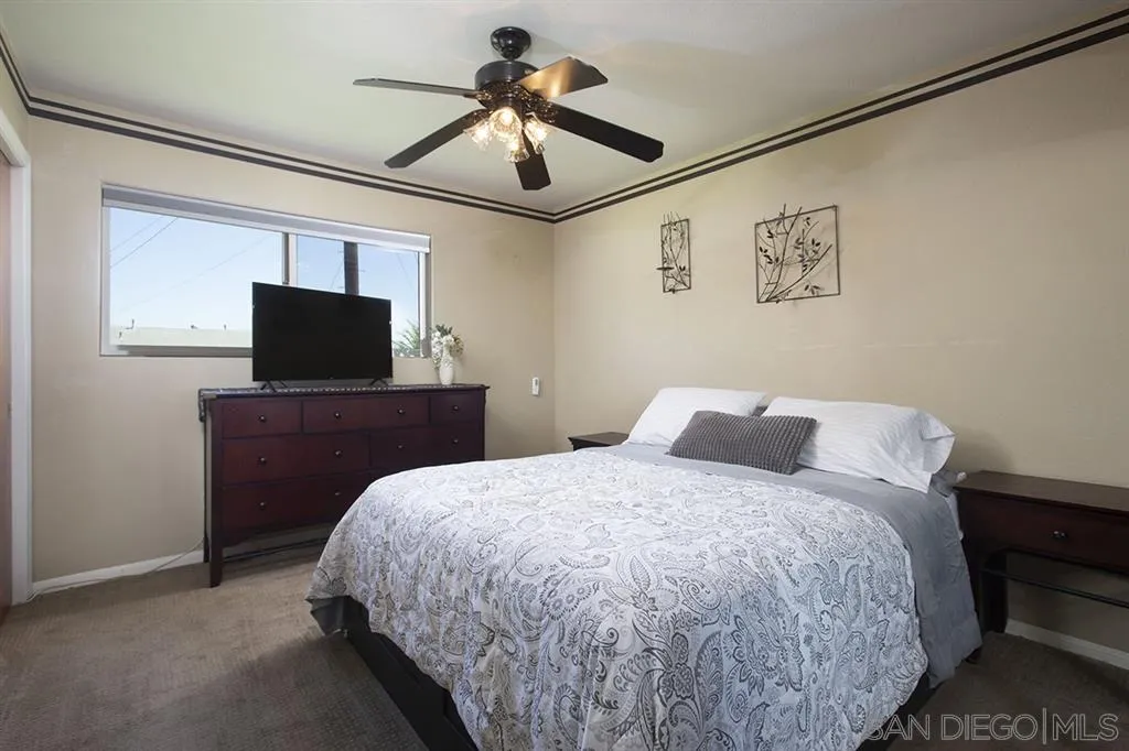 9228 Bellagio Road Santee, CA 92071 - Photo 12 of 25 a bedroom with a bed and a flat screen tv