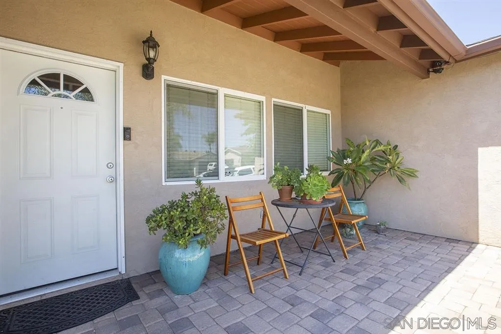 9228 Bellagio Road Santee, CA 92071 - Photo 3 of 25 a view of a porch with chairs and potted plants