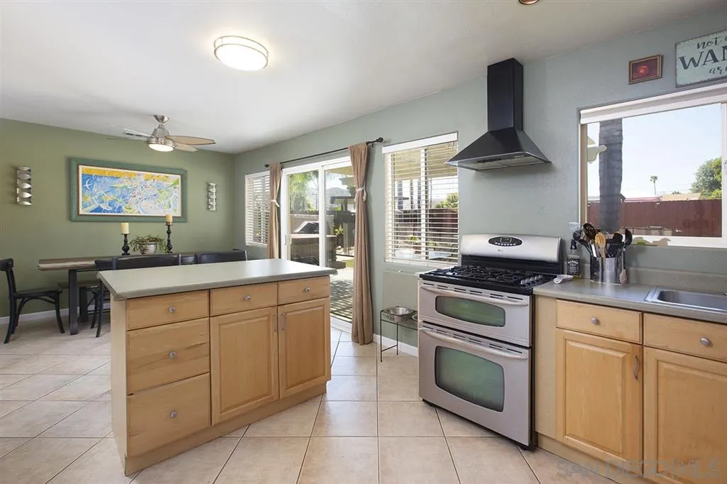 9228 Bellagio Road Santee, CA 92071 - Photo 10 of 25 a kitchen with stainless steel appliances a stove sink and cabinets