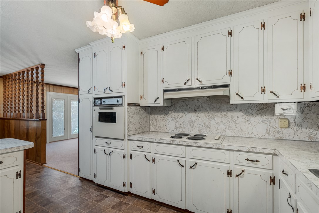 2101 Old Spring Drive Anderson, SC 29625 - Photo 12 of 36 A well-appointed kitchen features ample white cabinetry, integrated appliances, and a durable tile floor.