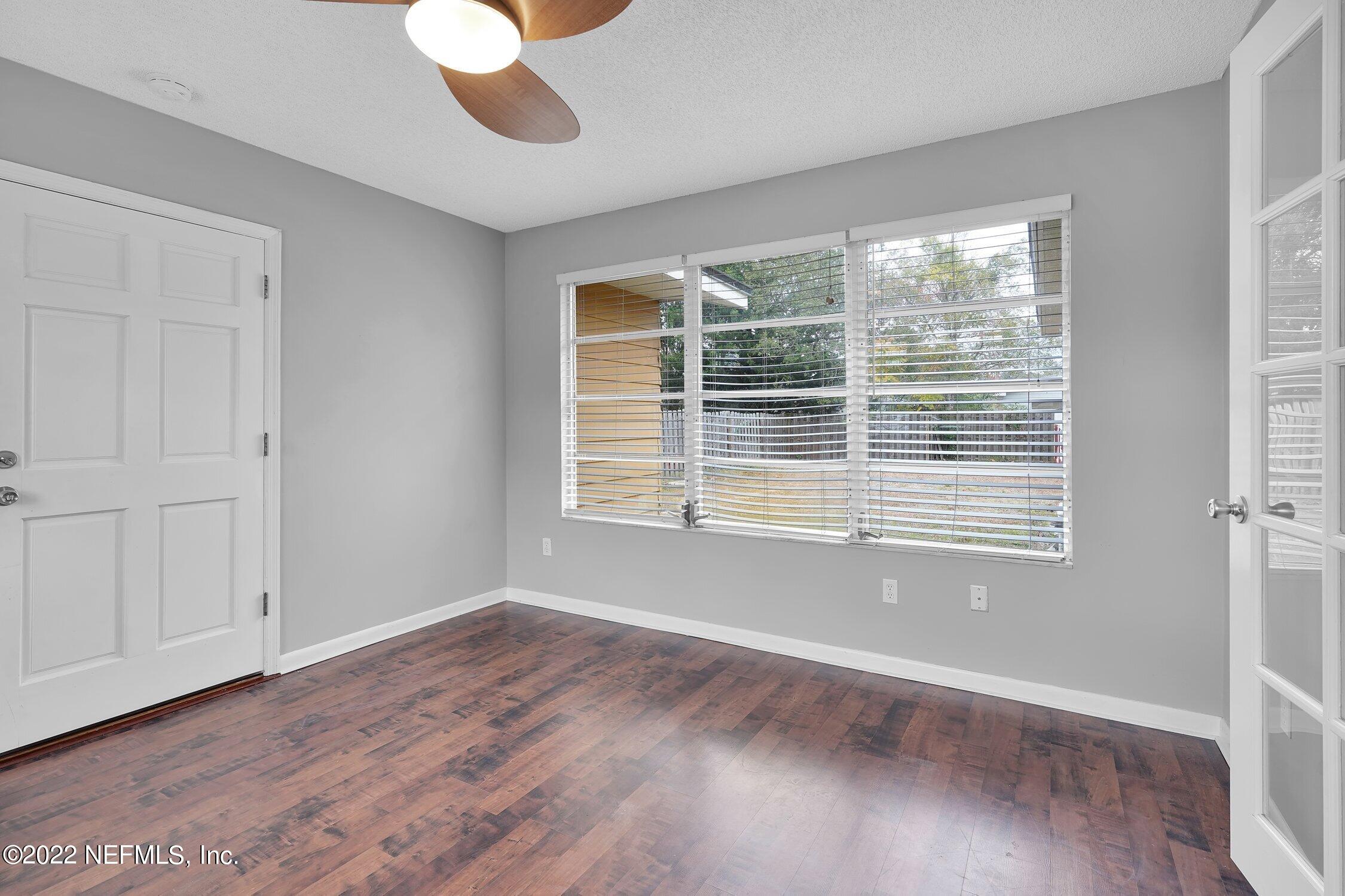 208 Baracoa Court St. Augustine, FL 32086 - Photo 11 of 32 a view of an empty room with wooden floor and a window