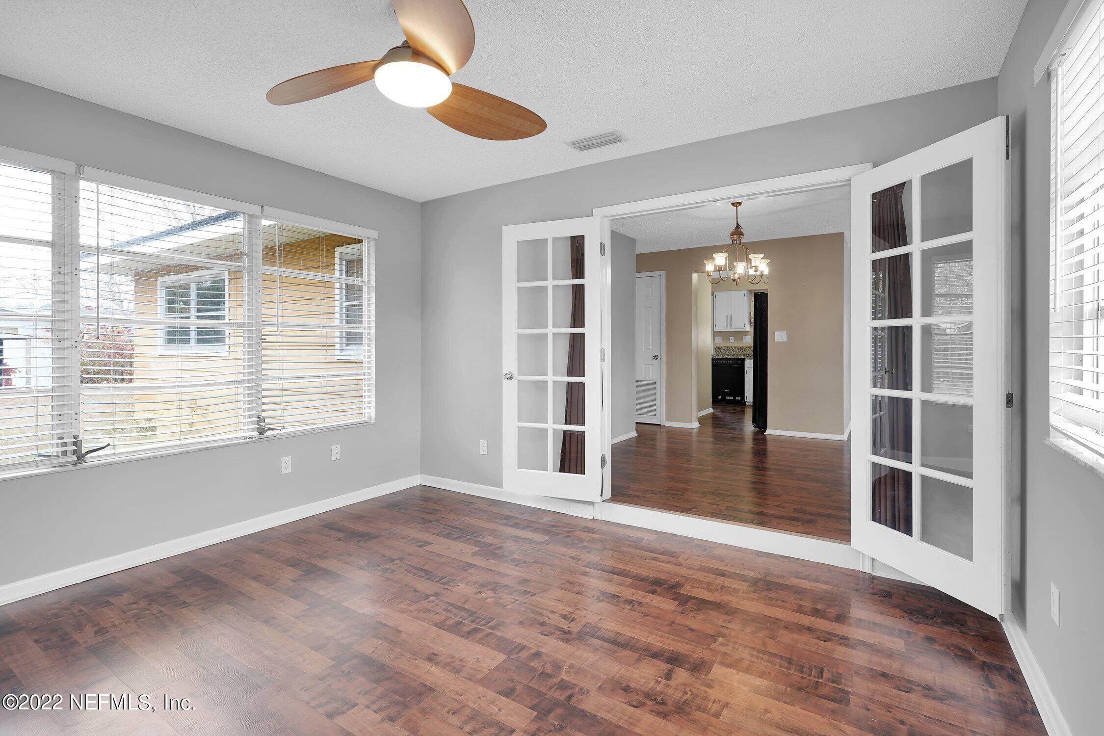 208 Baracoa Court St. Augustine, FL 32086 - Photo 13 of 32 a view of an empty room with a window and wooden floor