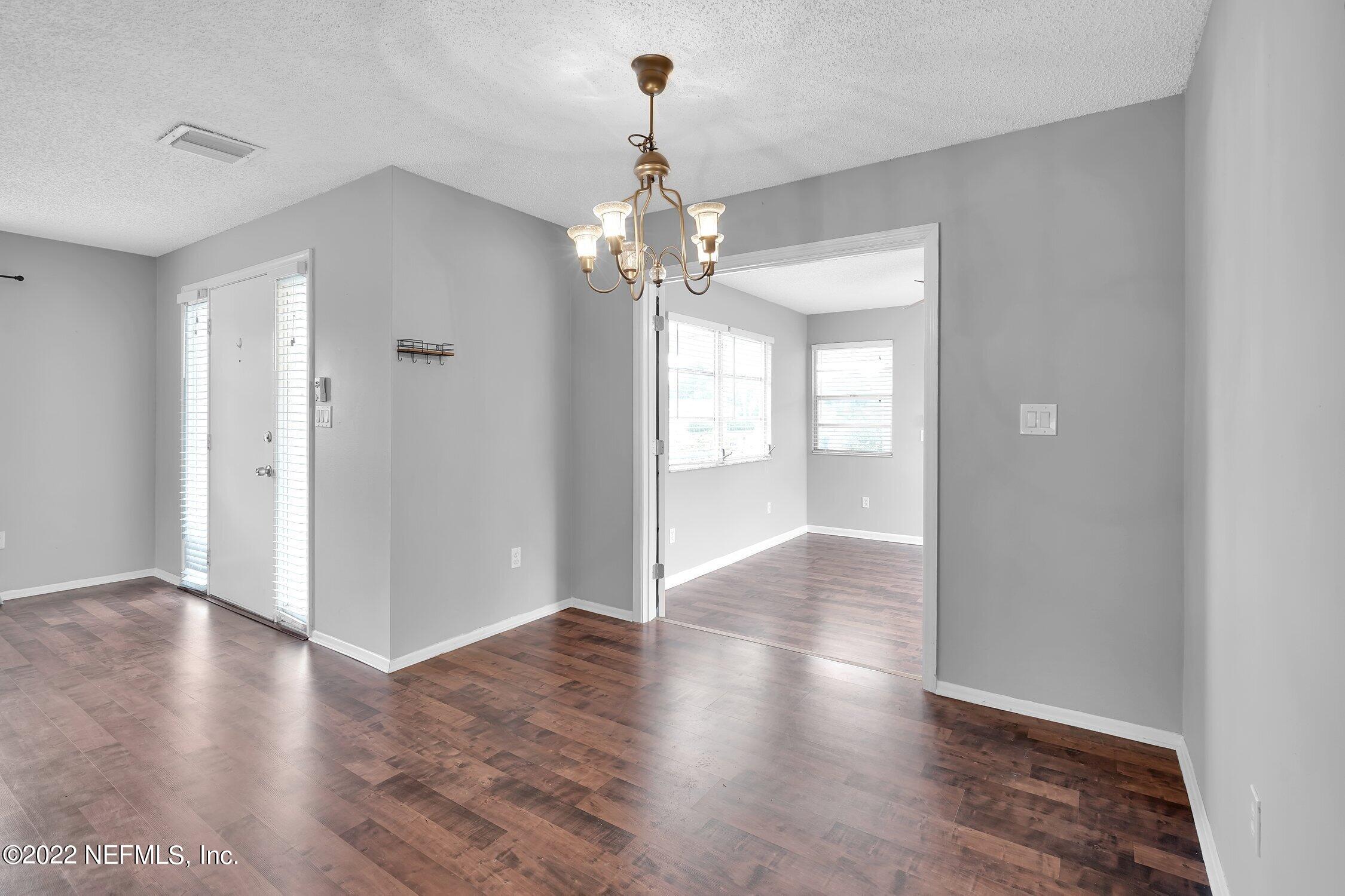 208 Baracoa Court St. Augustine, FL 32086 - Photo 15 of 32 a view of an empty room with wooden floor and a window