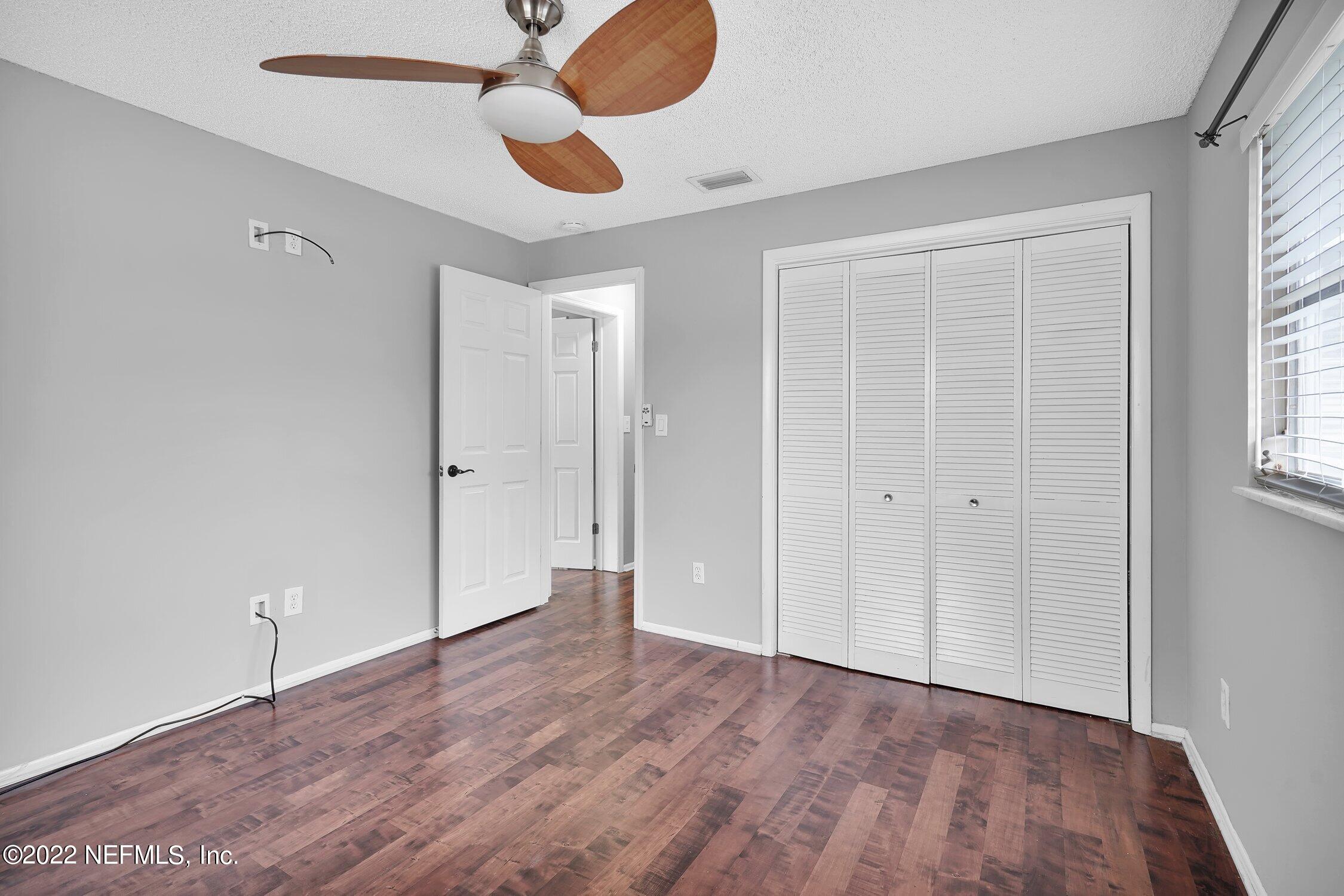 208 Baracoa Court St. Augustine, FL 32086 - Photo 23 of 32 wooden floor in an empty room with a window