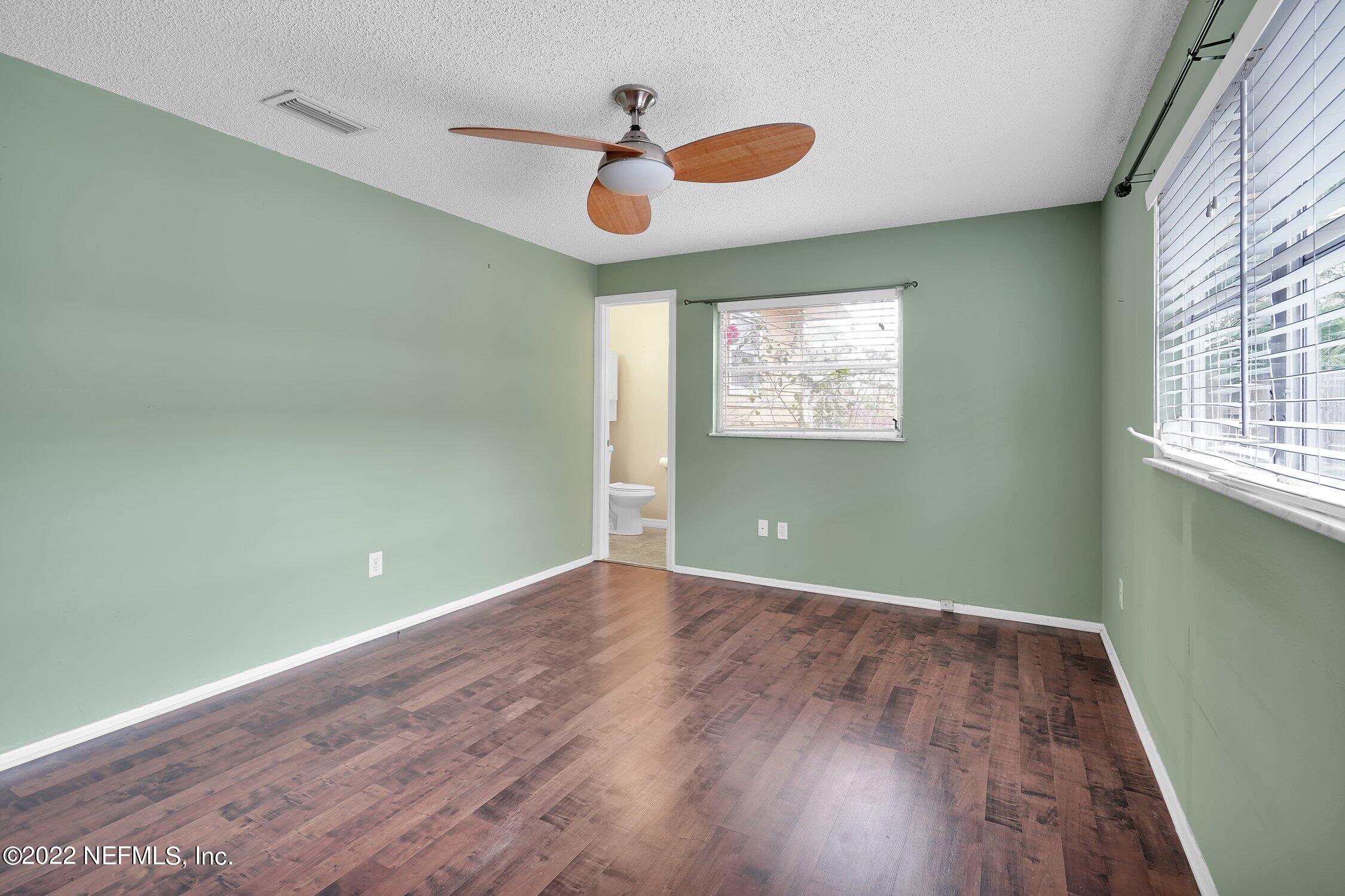 208 Baracoa Court St. Augustine, FL 32086 - Photo 25 of 32 an empty room with wooden floor and windows
