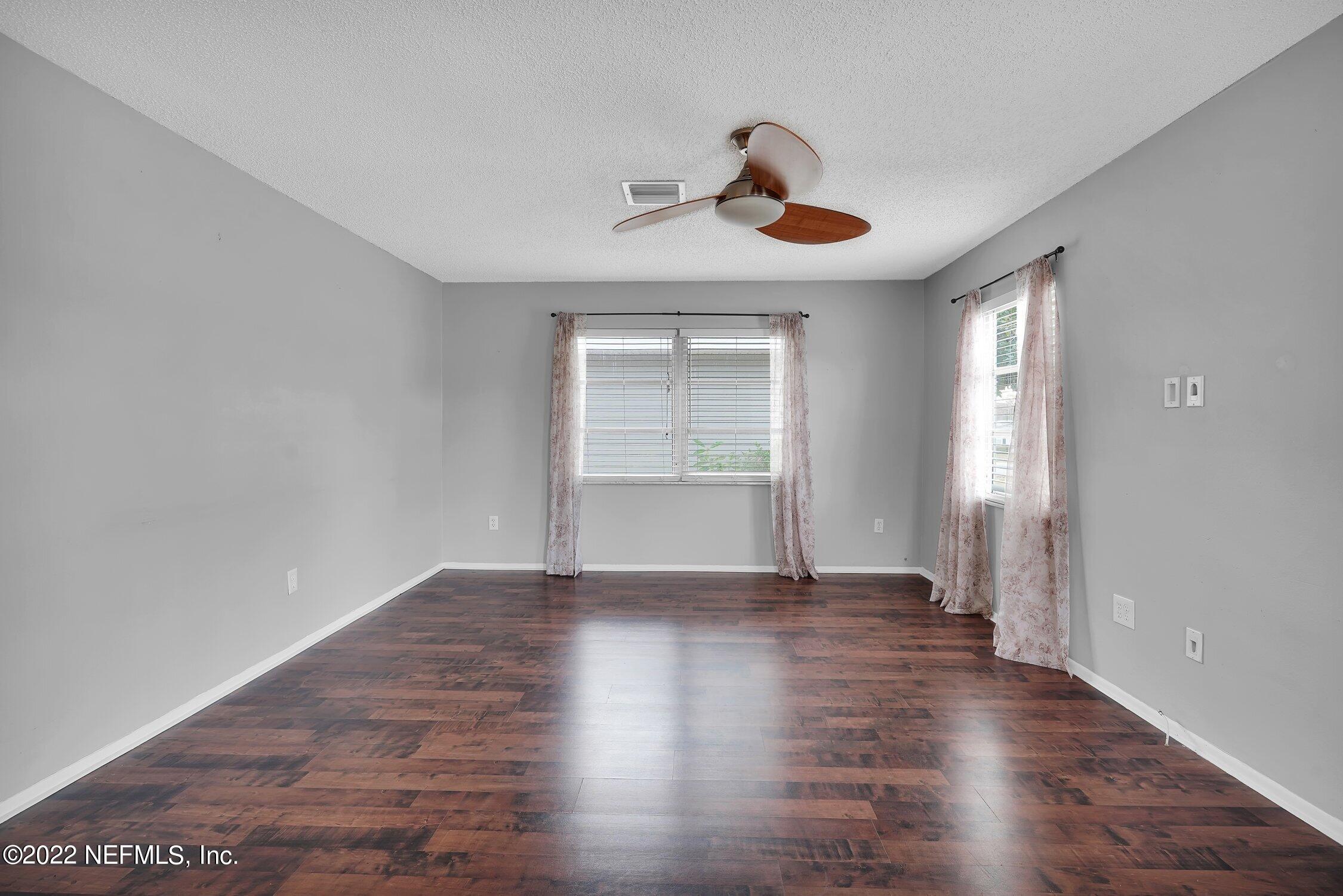 208 Baracoa Court St. Augustine, FL 32086 - Photo 5 of 32 a view of an empty room with window and wooden floor