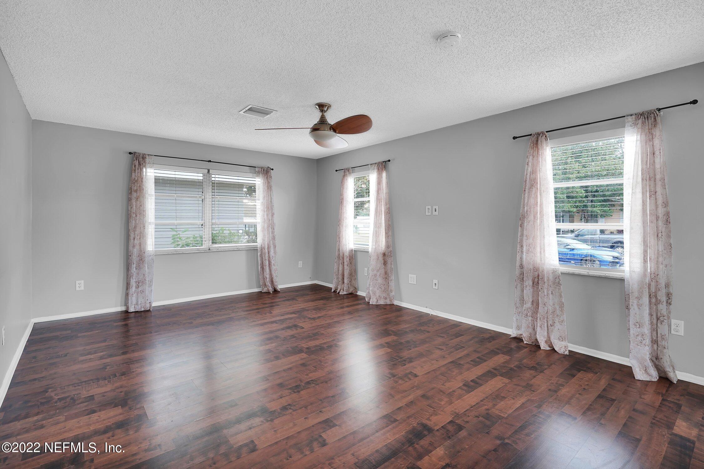 208 Baracoa Court St. Augustine, FL 32086 - Photo 6 of 32 an empty room with wooden floor and windows