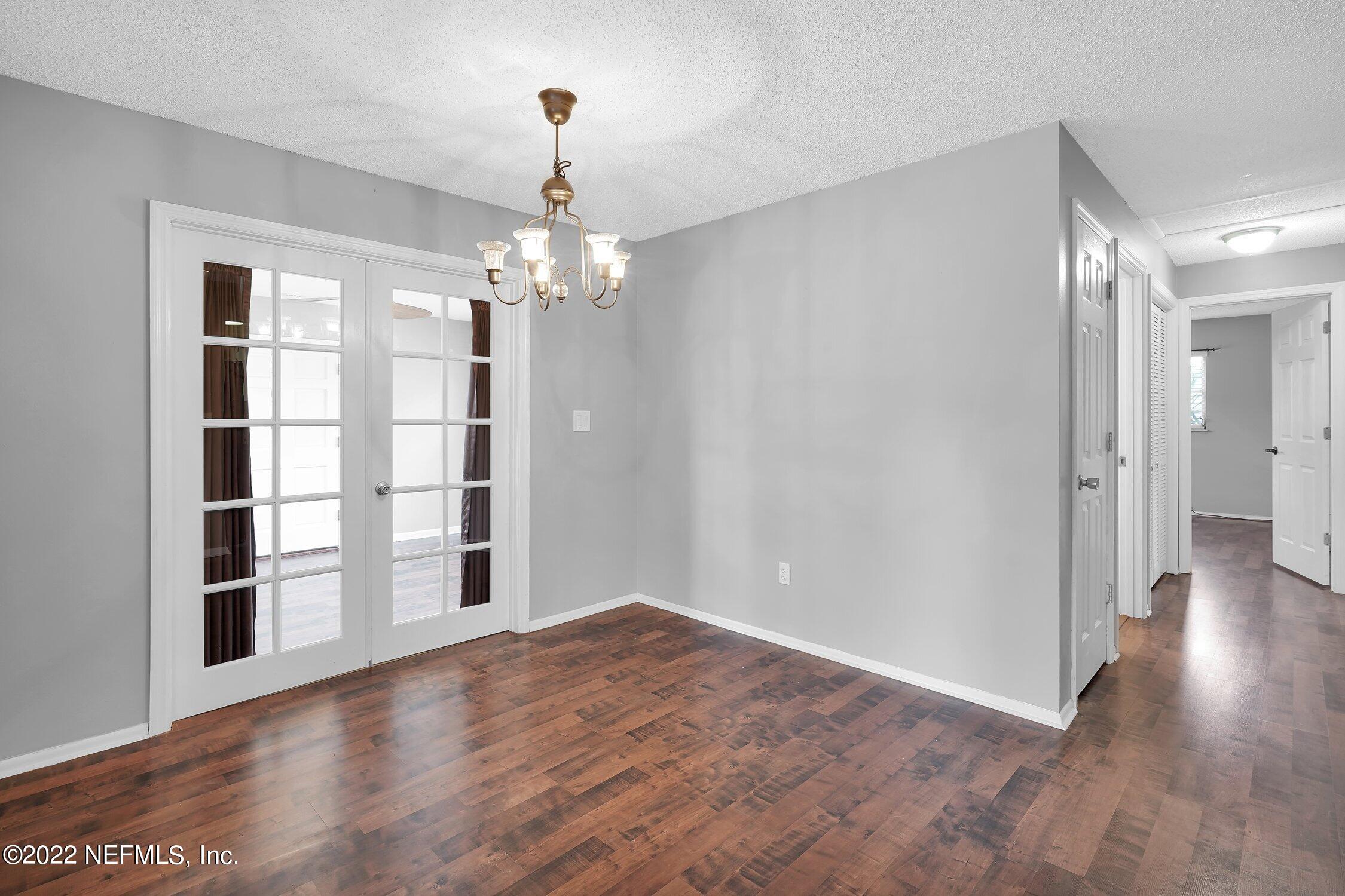 208 Baracoa Court St. Augustine, FL 32086 - Photo 9 of 32 wooden floor in an empty room with a window