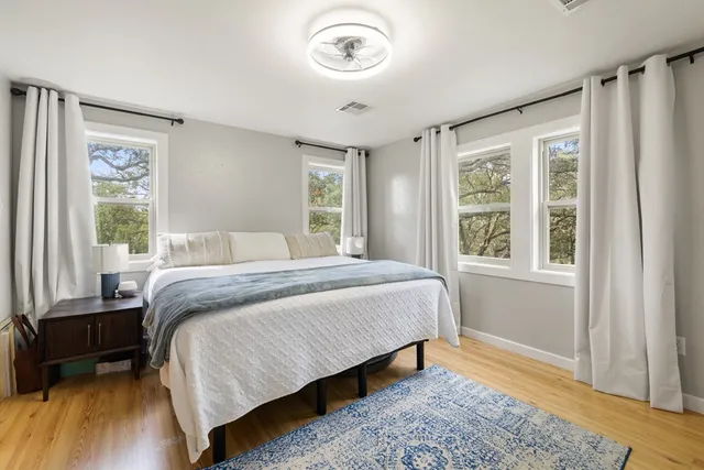 a bedroom with a bed and a window