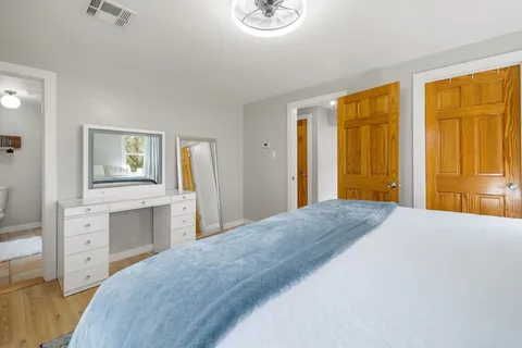 a bedroom with a bed and a dresser