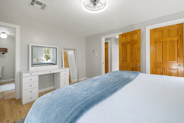 a bedroom with a bed and a dresser