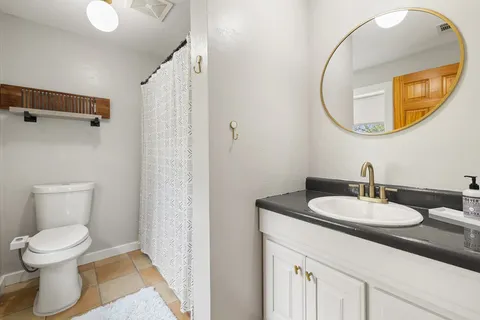 a bathroom with a toilet a sink and a mirror