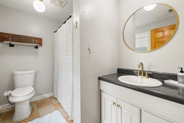 a bathroom with a toilet a sink and a mirror