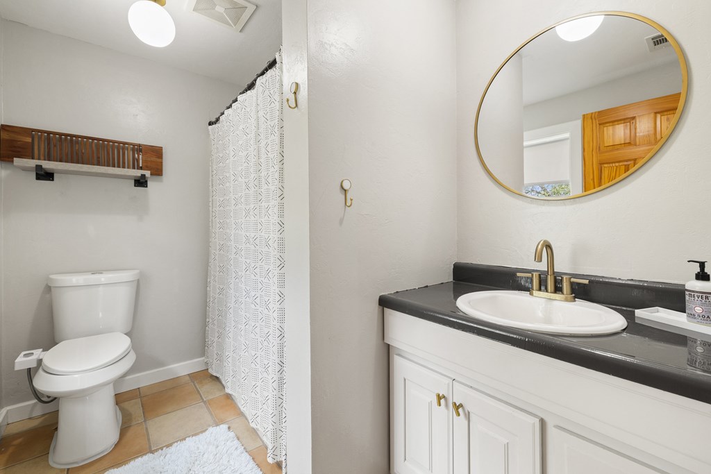 396 Ranch Road 2721 Johnson City, TX 78636 - Photo 20 of 36 a bathroom with a toilet a sink and a mirror