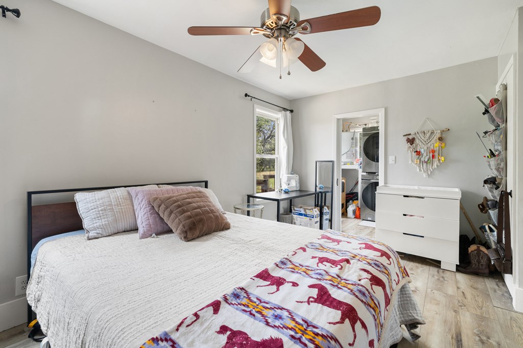396 Ranch Road 2721 Johnson City, TX 78636 - Photo 24 of 36 a bedroom with a bed and a chandelier