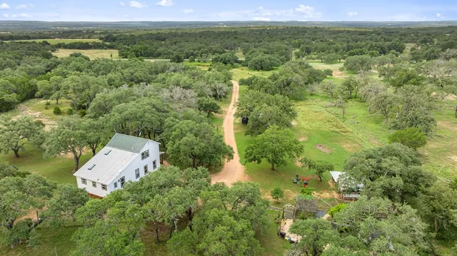 an aerial view of a house with a yard