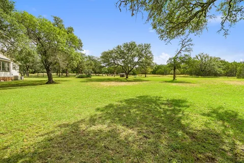 a view of a big yard with a fountain