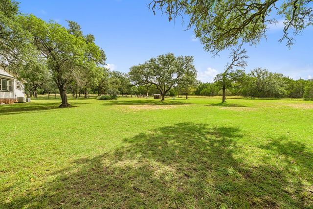 a view of a big yard with a fountain