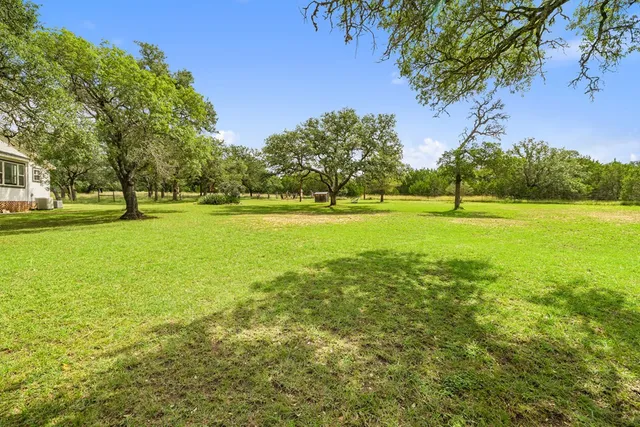 a view of a big yard with a fountain