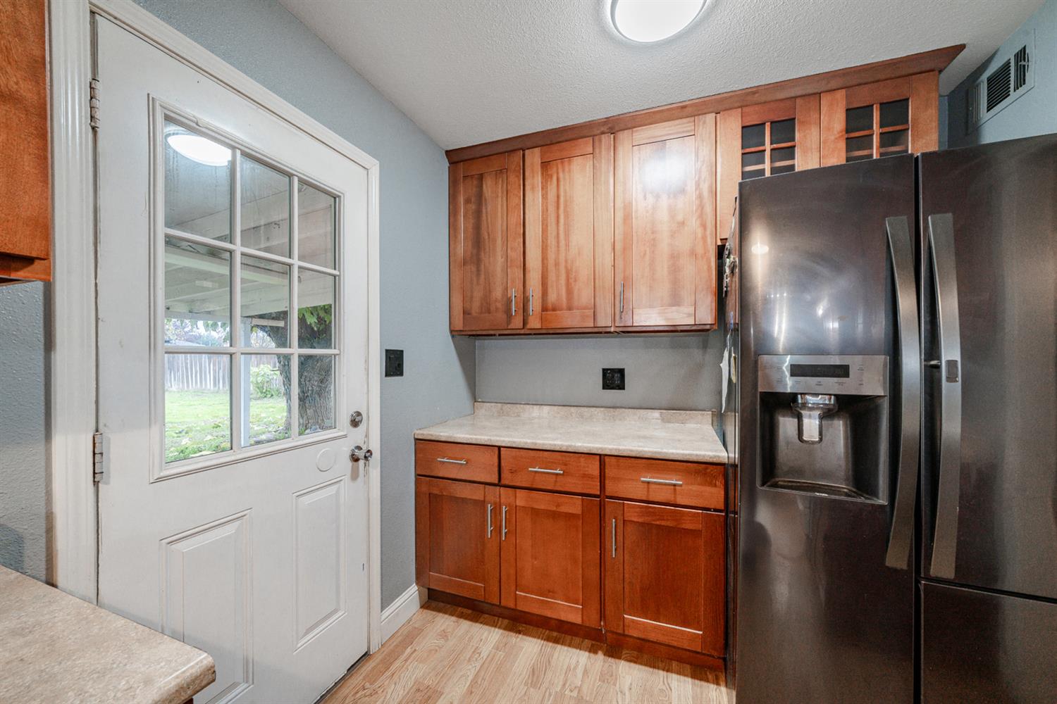 27152 Perkins Road Madera, CA 93637 - Photo 14 of 25 a kitchen with stainless steel appliances granite countertop a refrigerator a stove and a sink with large window