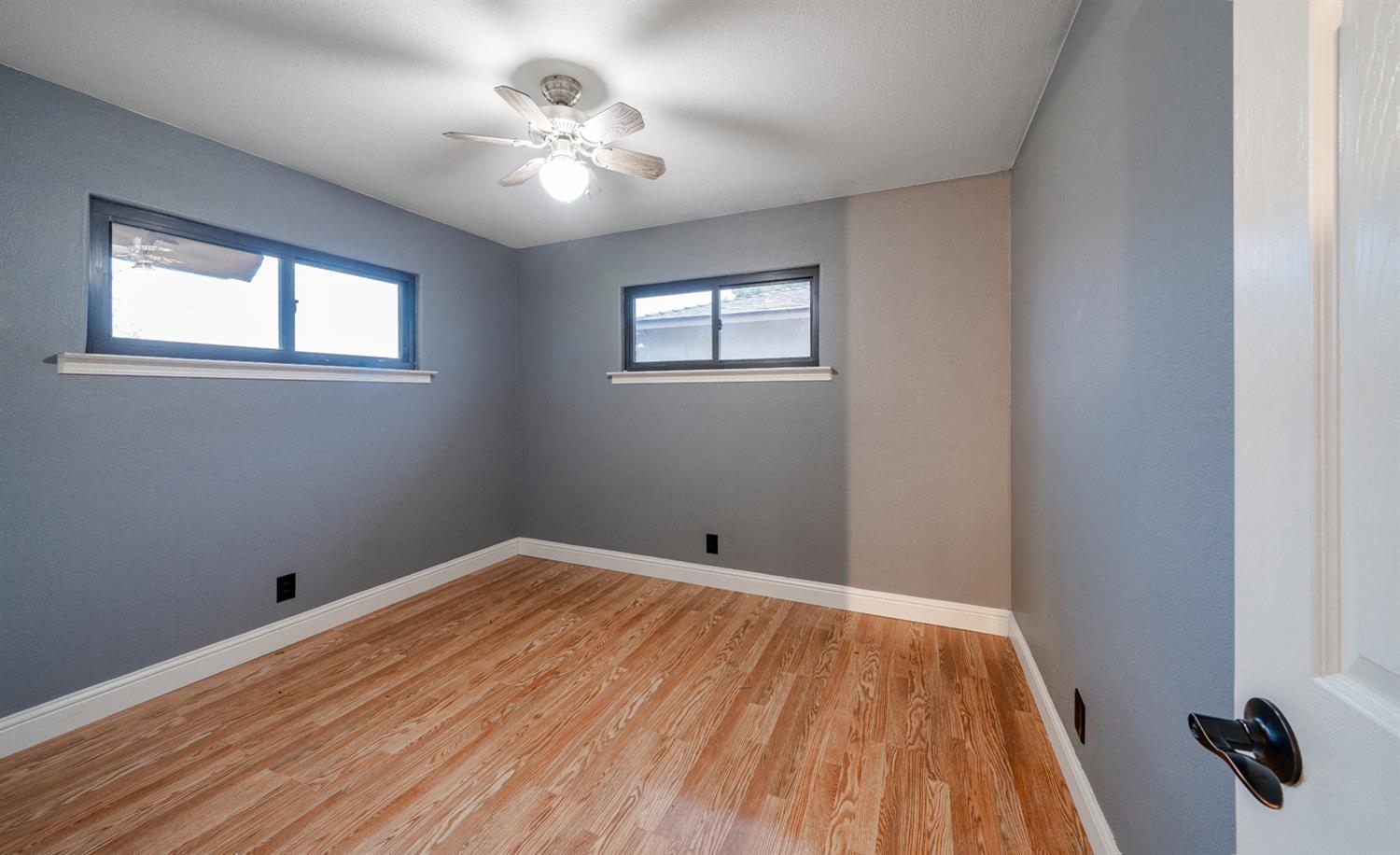 27152 Perkins Road Madera, CA 93637 - Photo 17 of 25 a view of a room with wooden floor and a ceiling fan