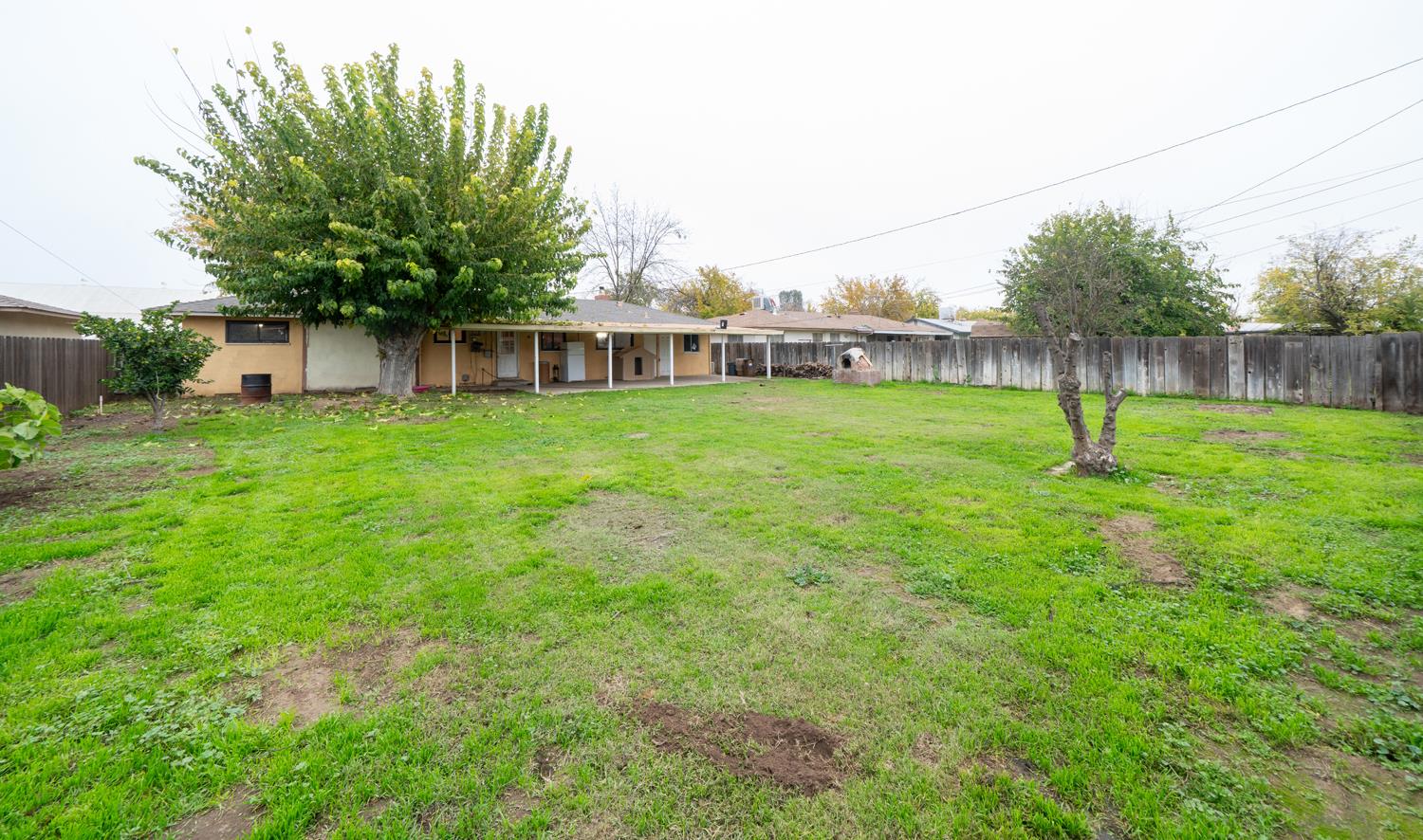 27152 Perkins Road Madera, CA 93637 - Photo 24 of 25 a house with green field in front of it